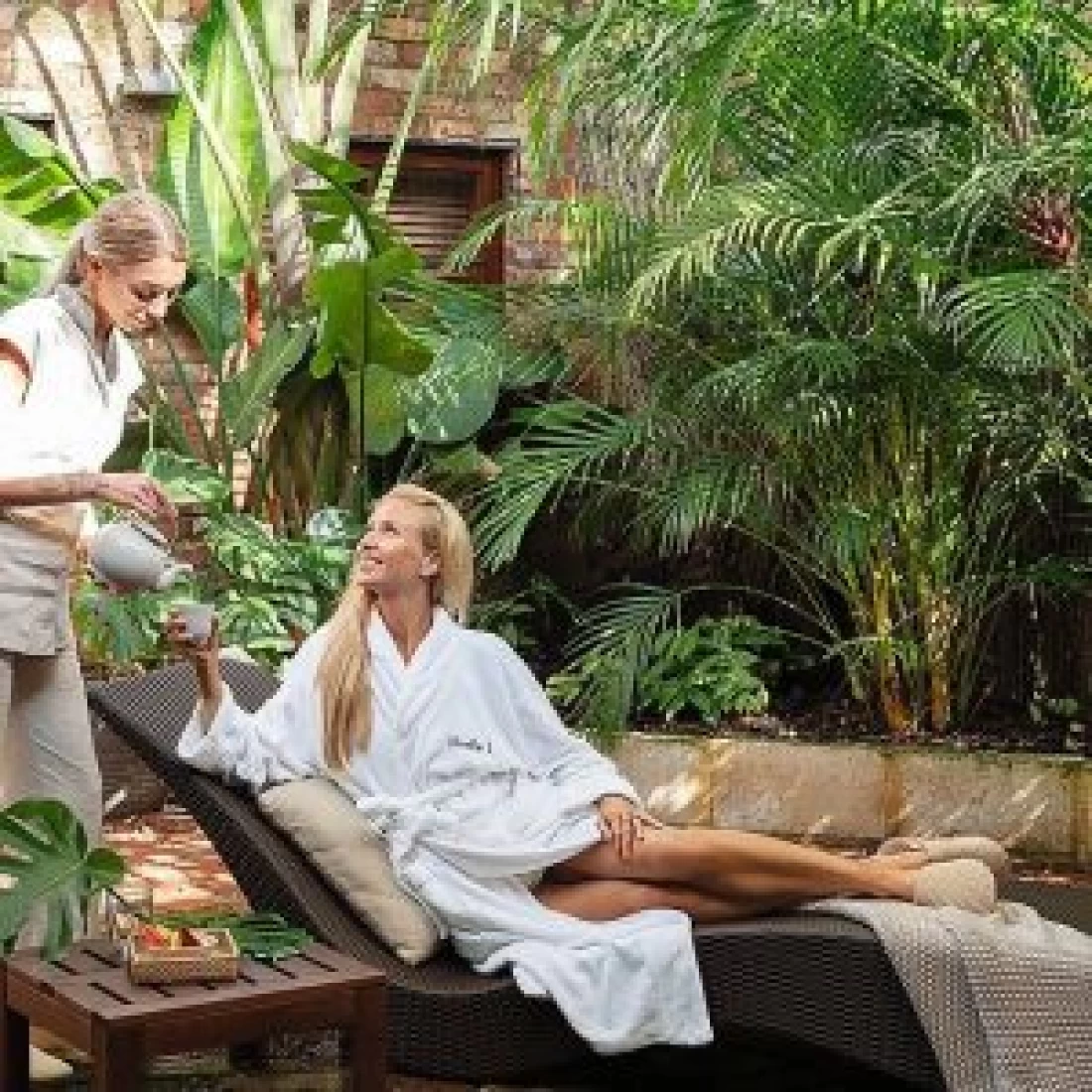 Expecting mum resting outdoors in a bathrobe at a spa offering the Best Pregnancy Massage