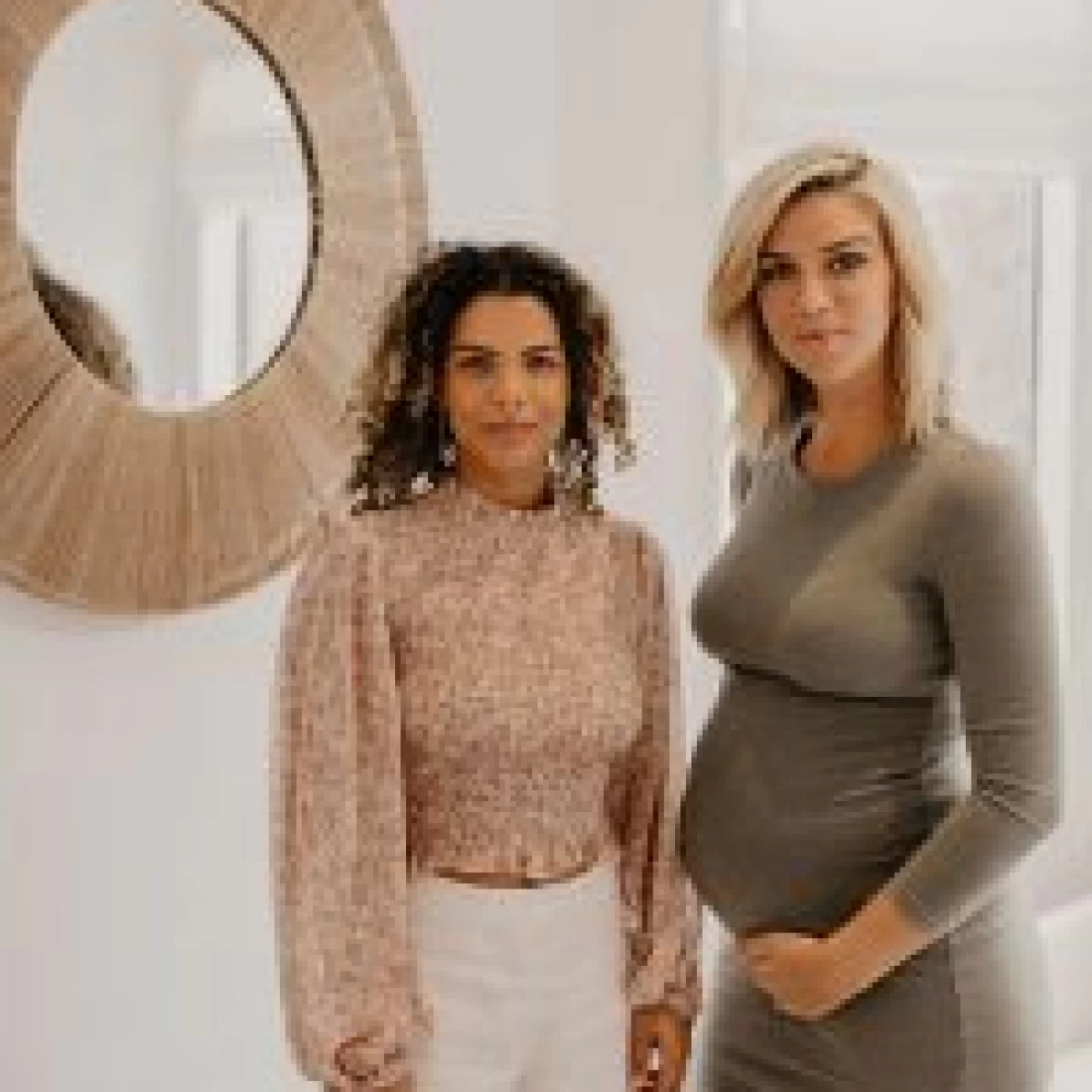 Expecting mother standing next to the massager before enjoying the Best Pregnancy Massage.