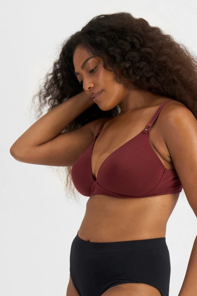 A woman wearing the bonds maternity bra, shown on the side
