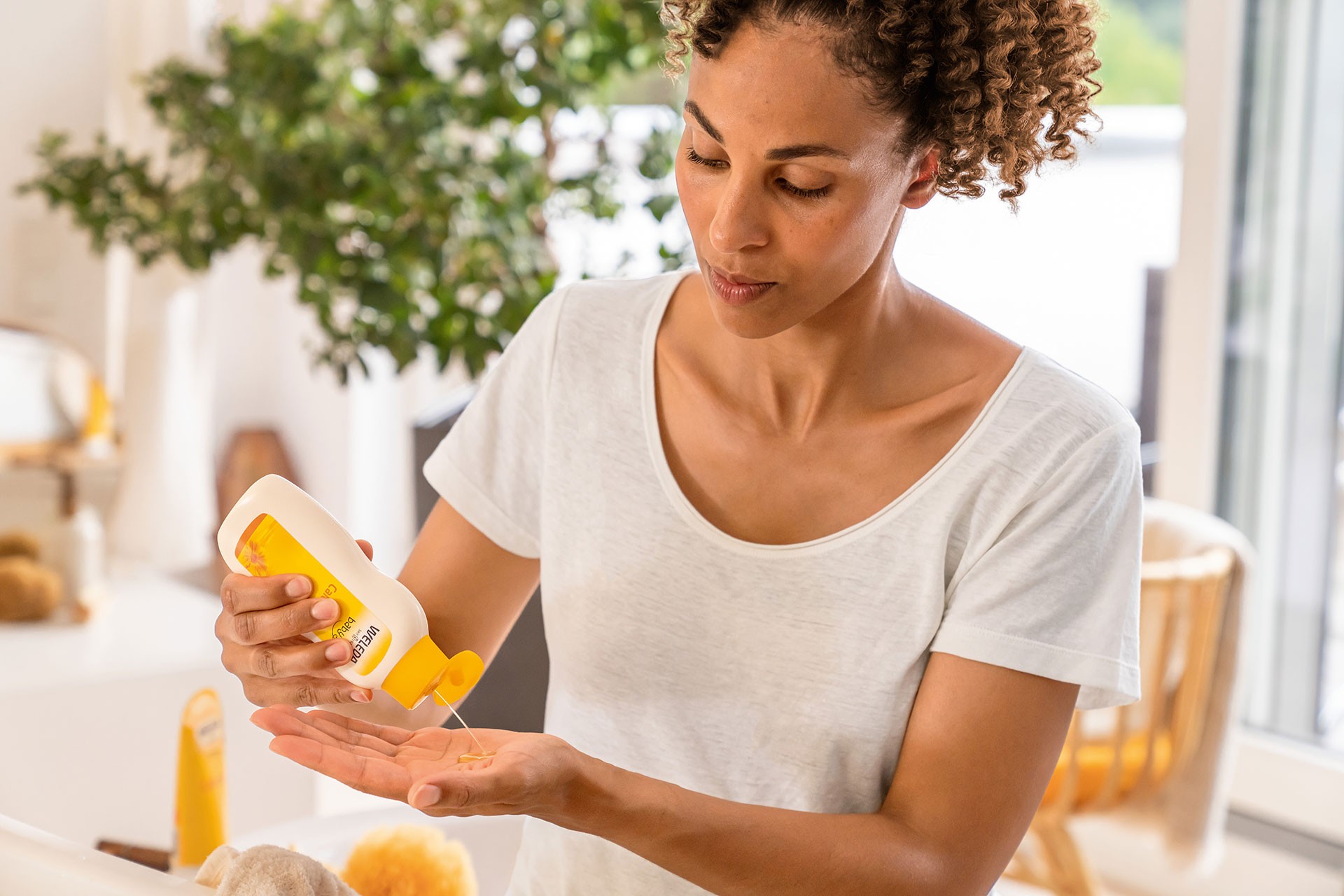 Weleda baby shampoo and body wash used by mum during bath time for gentle cleansing and natural baby care.