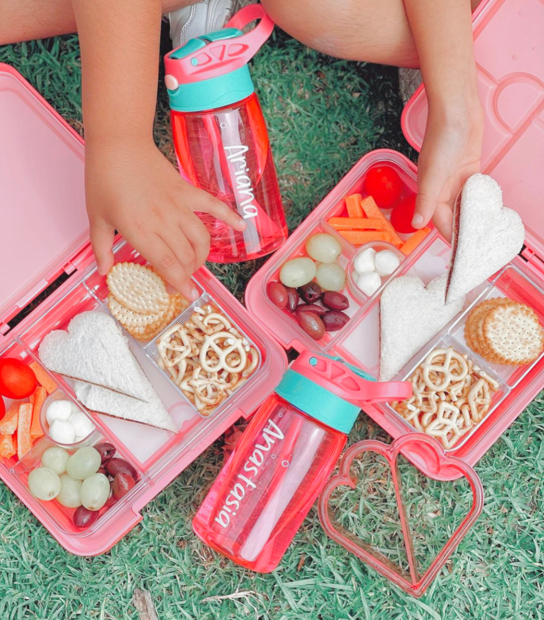Overhead view of kids’ bento lunch boxes filled with food, demonstrating practical and stylish best kids' lunch boxes for school.