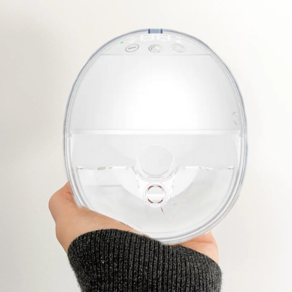 Hand holding a compact wearable breast pump as an example of how to choose the right breast pump.