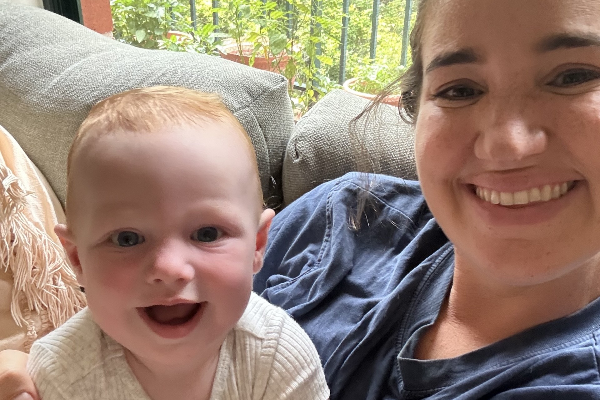 mum holding smiling baby