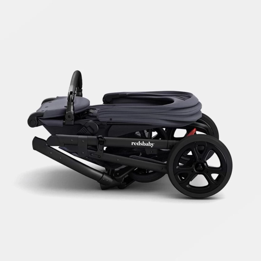 Folded Redsbaby METRO³ Lite Stroller, highlighting lightweight and space-saving design.