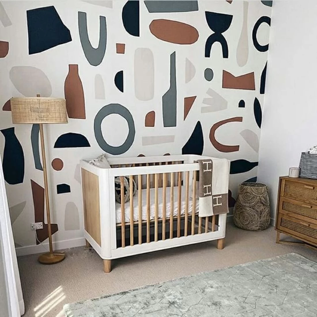 Creative art shapes nursery decor with abstract wall art, reflecting the best baby boy nursery room decor ideas.