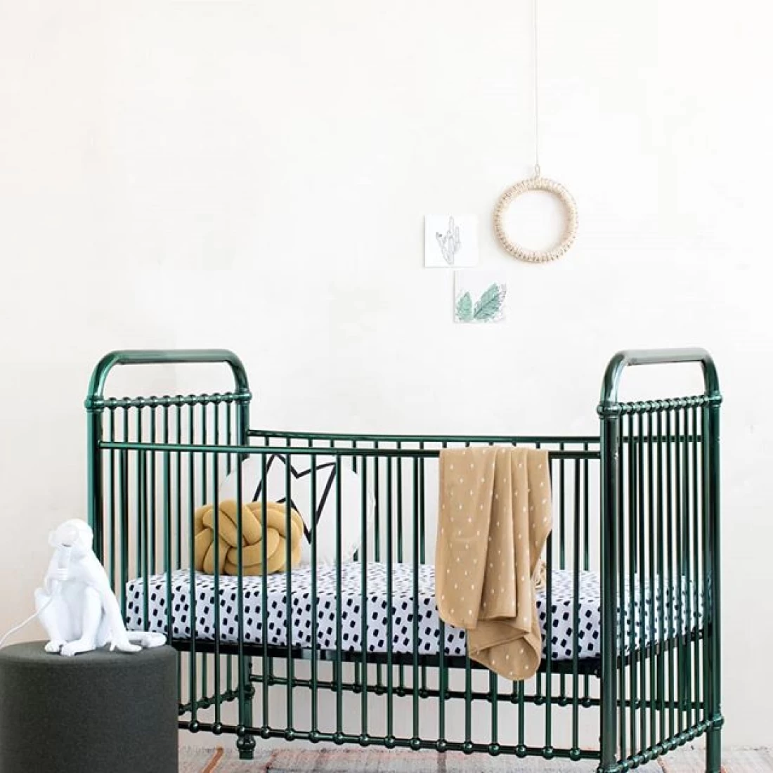 Nursery with black crib and white wall background, reflecting the best baby boy nursery room decor ideas.