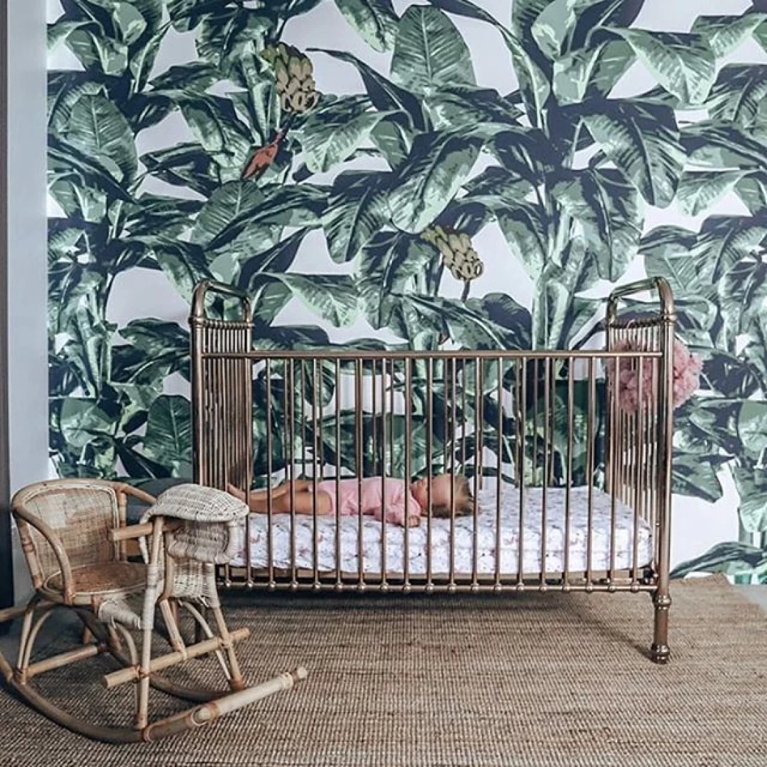 Modern jungle nursery design with leafy greens and animal decor, reflecting the best baby boy nursery room decor ideas.